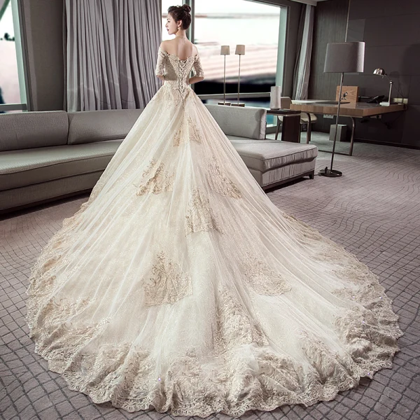 Stunning Champagne Wedding Dresses 2019 Ball Gown Off-The-Shoulder 1/2 Sleeves Backless Appliques Lace Cathedral Train Ruffle