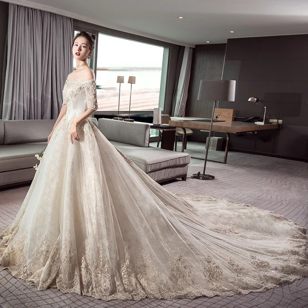 Stunning Champagne Wedding Dresses 2019 Ball Gown Off-The-Shoulder 1/2 Sleeves Backless Appliques Lace Cathedral Train Ruffle