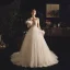 Illusion Champagne Genomskinliga Bröllopsklänningar 2019 Prinsessa Fyrkantig Ringning Långärmad Fjäder Halterneck Appliqués Spets Pierced Beading Domstol Tåg