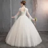 Affordable Champagne See-through Outdoor / Garden Wedding Dresses 2019 Ball Gown High Neck Bell sleeves Backless Appliques Lace Pearl Beading Floor-Length / Long Ruffle