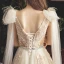 Chic / Belle Champagne Transparentes Robe De Mariée 2019 Princesse Col v profond Sans Manches Dos Nu Appliques En Dentelle Perlage Perle Plumes Ceinture Tribunal Train Volants