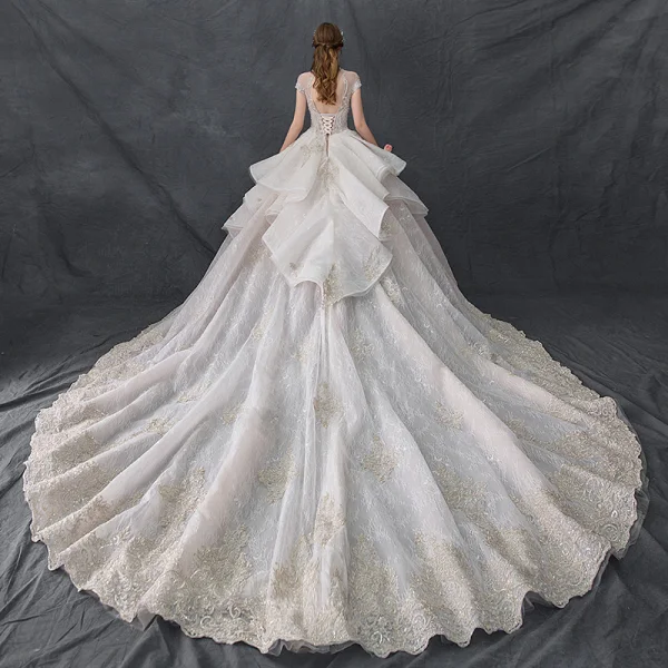 Luxury / Gorgeous Vintage / Retro Champagne See-through Wedding Dresses 2019 Ball Gown High Neck Cap Sleeves Backless Appliques Lace Handmade  Beading Cathedral Train Ruffle