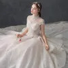 Luxury / Gorgeous Vintage / Retro Champagne See-through Wedding Dresses 2019 Ball Gown High Neck Cap Sleeves Backless Appliques Lace Handmade  Beading Cathedral Train Ruffle