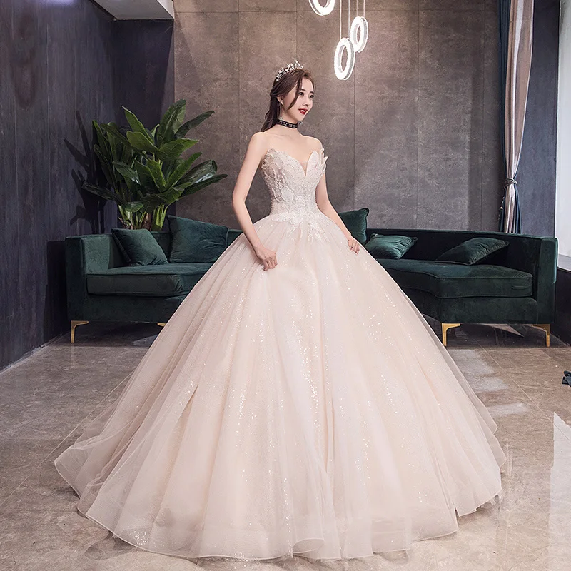 Sjarmerende Champagne Korsett Brudekjoler 2019 Prinsesse Kjæreste Uten Ermer Ryggløse Appliques Blonder Beading Glitter Tyll Cathedral Train