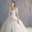 Schöne Champagner Durchsichtige Brautkleider / Hochzeitskleider 2019 A Linie Rundhalsausschnitt Kurze Ärmel Perlenstickerei Quaste Rückenfreies Applikationen Spitze Kapelle-Schleppe Rüschen