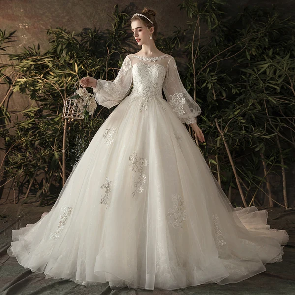Elegante Ivory / Creme Durchsichtige Brautkleider / Hochzeitskleider 2019 Prinzessin Rundhalsausschnitt Geschwollenes Lange Ärmel Rückenfreies Applikationen Spitze Kapelle-Schleppe Rüschen