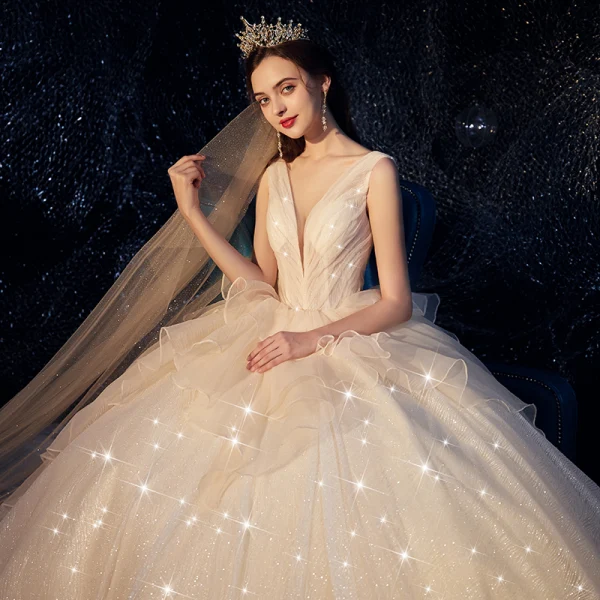 Bling Bling Champagne Wedding Dresses 2019 Ball Gown Deep V-Neck Sleeveless Backless Glitter Tulle Ruffle Cathedral Train
