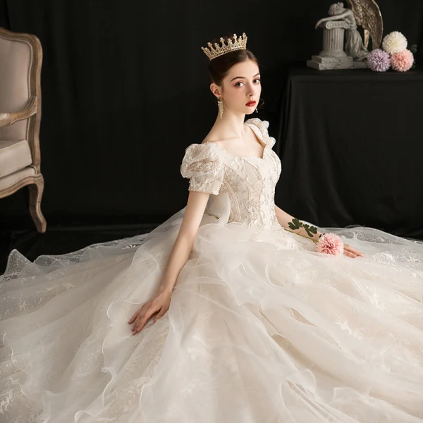 Viktorianischer Stil Vintage Champagner Brautkleider / Hochzeitskleider 2019 A Linie Eckiger Ausschnitt Geschwollenes Kurze Ärmel Rückenfreies Schleife Glanz Tülle Applikationen Spitze Perlenstickerei Kathedrale Schleppe Rüschen