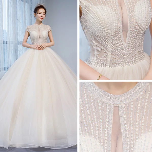 Charmant Champagner Durchsichtige Brautkleider / Hochzeitskleider 2020 Ballkleid Rundhalsausschnitt Ärmel Rückenfreies Perlenstickerei Glanz Tülle Kapelle-Schleppe Rüschen