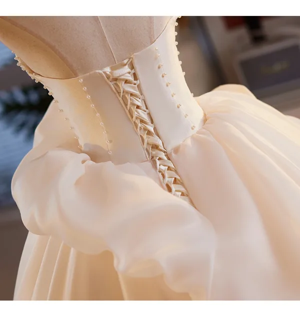 Elegant Champagne Pearl Appliques Satin Prom Dresses 2025 Ball Gown Strapless Bow Sleeveless Backless Sweep Train Formal Dresses