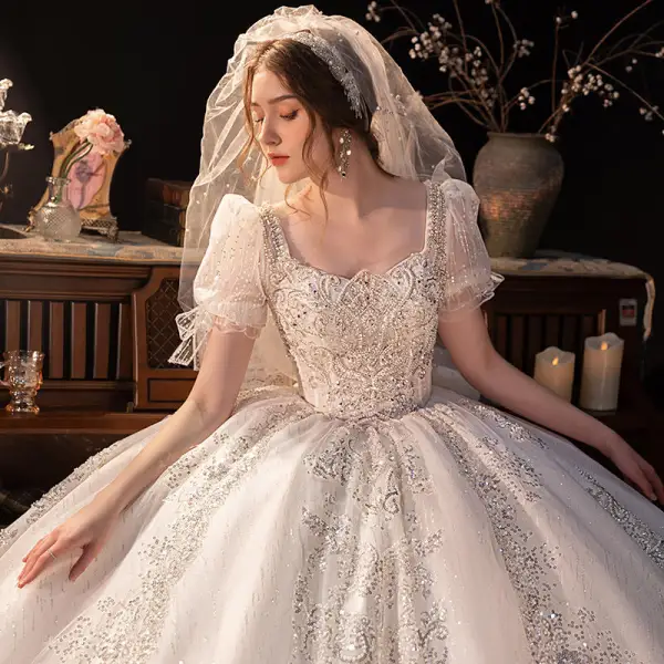 Atemberaubend Ivory / Creme Perlenstickerei Perle Strass Pailletten Spitze Blumen Brautkleider / Hochzeitskleider 2022 Ballkleid Eckiger Ausschnitt Kurze Ärmel Rückenfreies Schleife Kapelle-Schleppe Hochzeit