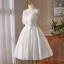 Charmant Blanche Faux Diamant Noeud de retour Robe De Graduation 2025 Robe Boule Bustier Sans Manches Dos Nu Longue Robe De Ceremonie